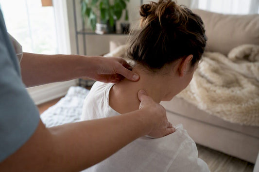 Hands pressing trigger point on neck muscles