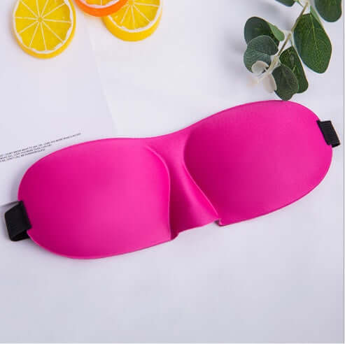 Sleep mask in vibrant pink color, designed for ultimate comfort and restful sleep, showcasing soft material and unique shape.