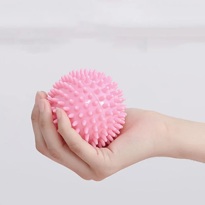 Person holding a pink Relaxing Foot Massage Ball for portable relief of tired, achy feet.