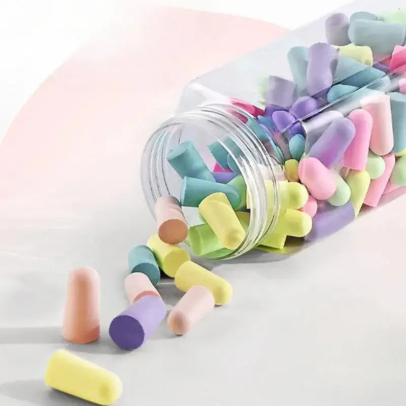 Colorful Sound Insulating Sleep Earplugs spilling from a clear jar, designed for peaceful sleep.